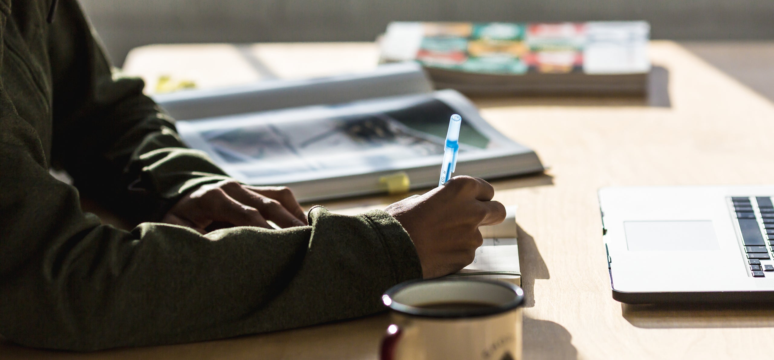 Man writing with a pensel at the desk